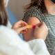 A doctor puts a bandaid on a patient's arm after giving them a vaccination